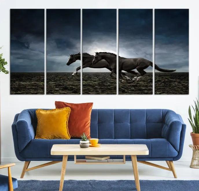 The Wild Horses Wall Art Canvas Print features a triptych of two galloping black horses set against a dark, cloudy landscape. This piece is gallery-wrapped on museum-quality canvas.