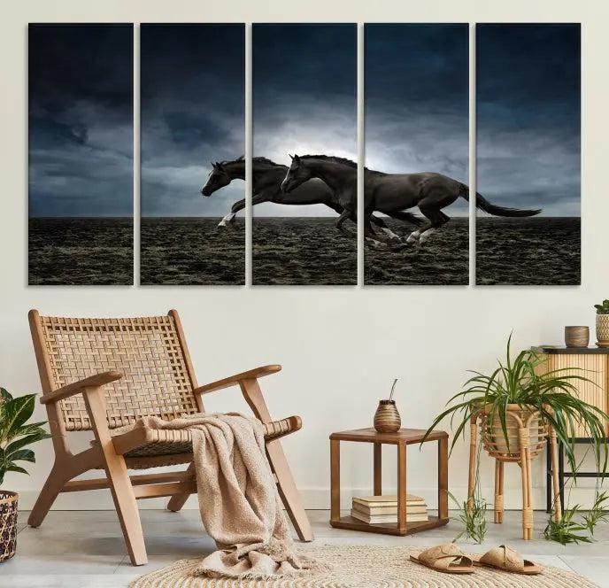 The Wild Horses Wall Art Canvas Print features a triptych of two galloping black horses set against a dark, cloudy landscape. This piece is gallery-wrapped on museum-quality canvas.