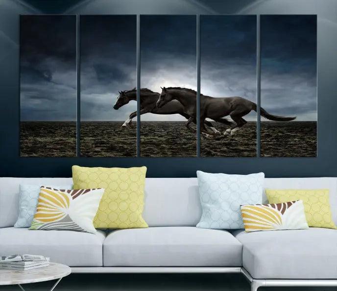 The Wild Horses Wall Art Canvas Print features a triptych of two galloping black horses set against a dark, cloudy landscape. This piece is gallery-wrapped on museum-quality canvas.