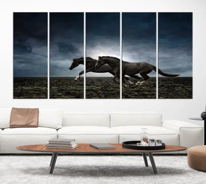 The Wild Horses Wall Art Canvas Print features a triptych of two galloping black horses set against a dark, cloudy landscape. This piece is gallery-wrapped on museum-quality canvas.