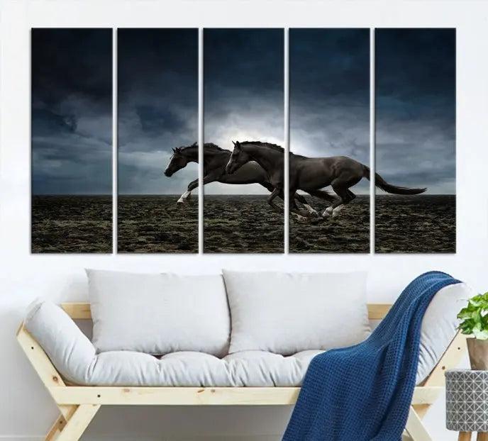 The Wild Horses Wall Art Canvas Print features a triptych of two galloping black horses set against a dark, cloudy landscape. This piece is gallery-wrapped on museum-quality canvas.