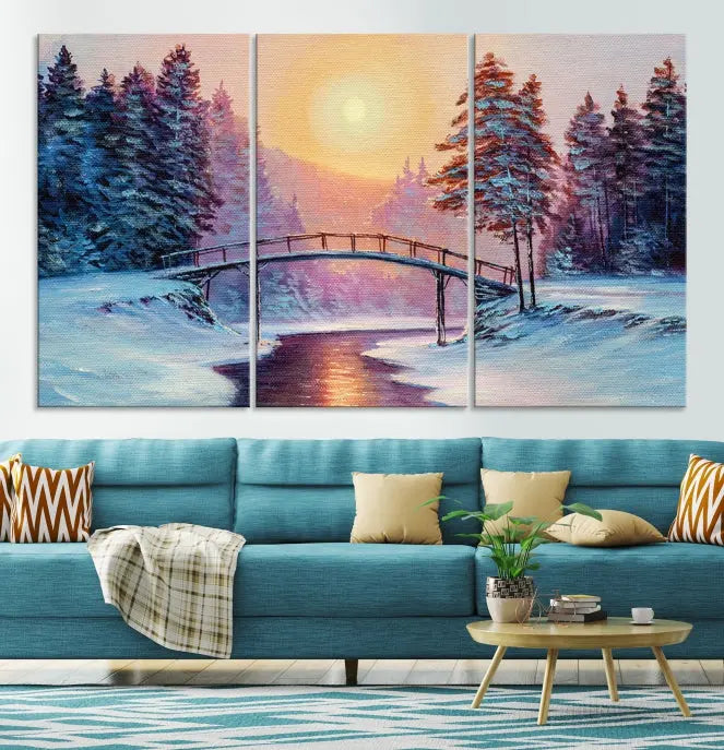 The "Winter Bridge Painting Wall Art Landscape Canvas Print" captures a serene winter landscape across three panels, showcasing a bridge, snowy trees, and a setting sun on museum-quality canvases. Each piece is gallery wrapped for an elegant finish that enhances the tranquility of the scene.