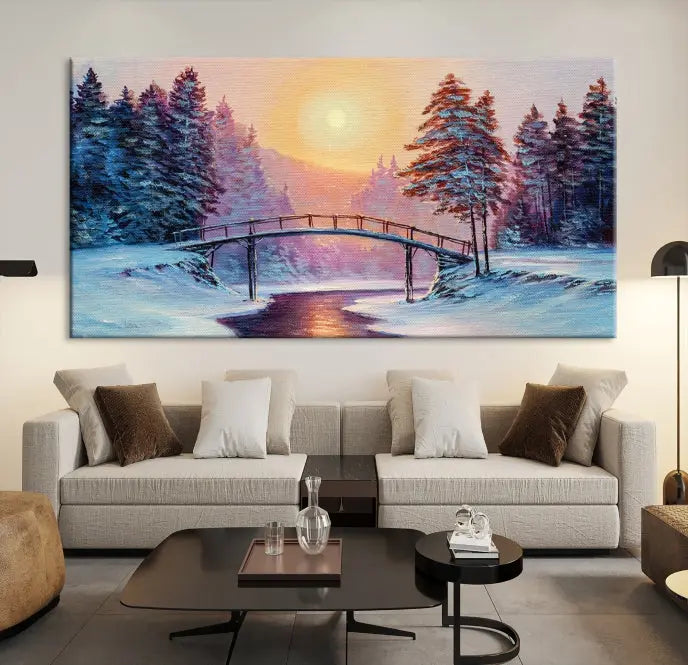 The "Winter Bridge Painting Wall Art Landscape Canvas Print" captures a serene winter landscape across three panels, showcasing a bridge, snowy trees, and a setting sun on museum-quality canvases. Each piece is gallery wrapped for an elegant finish that enhances the tranquility of the scene.