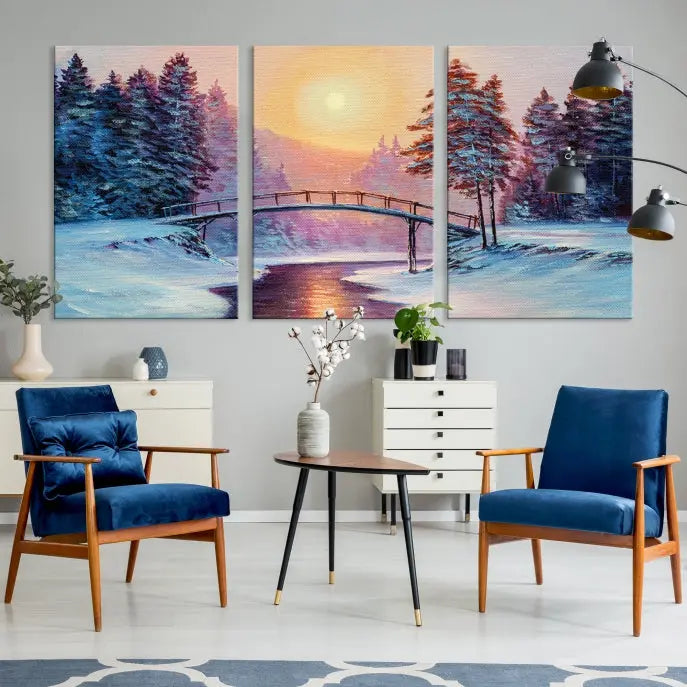 The "Winter Bridge Painting Wall Art Landscape Canvas Print" captures a serene winter landscape across three panels, showcasing a bridge, snowy trees, and a setting sun on museum-quality canvases. Each piece is gallery wrapped for an elegant finish that enhances the tranquility of the scene.