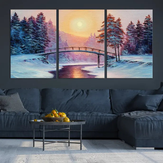 The "Winter Bridge Painting Wall Art Landscape Canvas Print" captures a serene winter landscape across three panels, showcasing a bridge, snowy trees, and a setting sun on museum-quality canvases. Each piece is gallery wrapped for an elegant finish that enhances the tranquility of the scene.