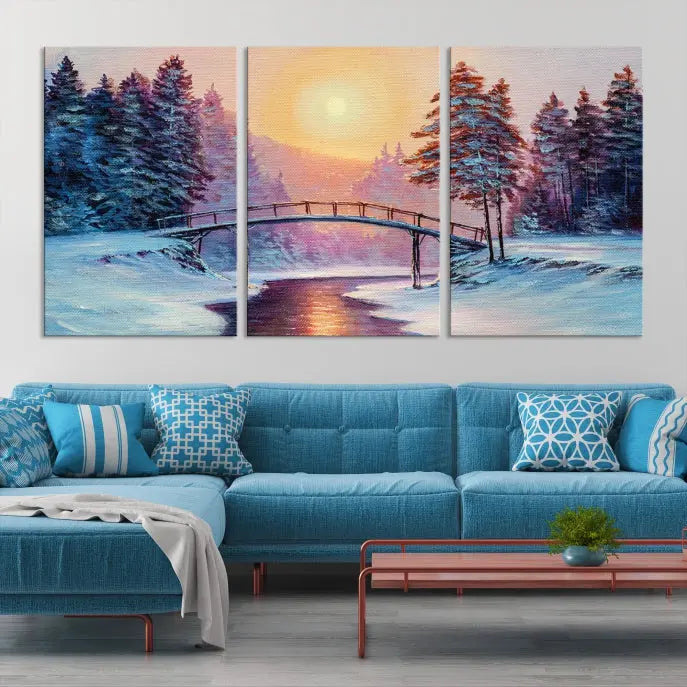 The "Winter Bridge Painting Wall Art Landscape Canvas Print" captures a serene winter landscape across three panels, showcasing a bridge, snowy trees, and a setting sun on museum-quality canvases. Each piece is gallery wrapped for an elegant finish that enhances the tranquility of the scene.