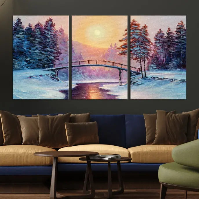 The "Winter Bridge Painting Wall Art Landscape Canvas Print" captures a serene winter landscape across three panels, showcasing a bridge, snowy trees, and a setting sun on museum-quality canvases. Each piece is gallery wrapped for an elegant finish that enhances the tranquility of the scene.