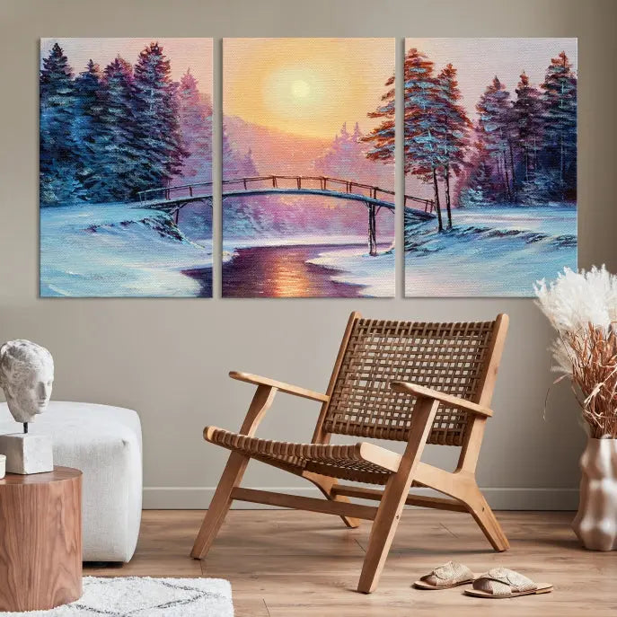 The "Winter Bridge Painting Wall Art Landscape Canvas Print" captures a serene winter landscape across three panels, showcasing a bridge, snowy trees, and a setting sun on museum-quality canvases. Each piece is gallery wrapped for an elegant finish that enhances the tranquility of the scene.