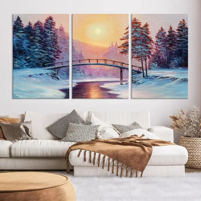 The "Winter Bridge Painting Wall Art Landscape Canvas Print" captures a serene winter landscape across three panels, showcasing a bridge, snowy trees, and a setting sun on museum-quality canvases. Each piece is gallery wrapped for an elegant finish that enhances the tranquility of the scene.