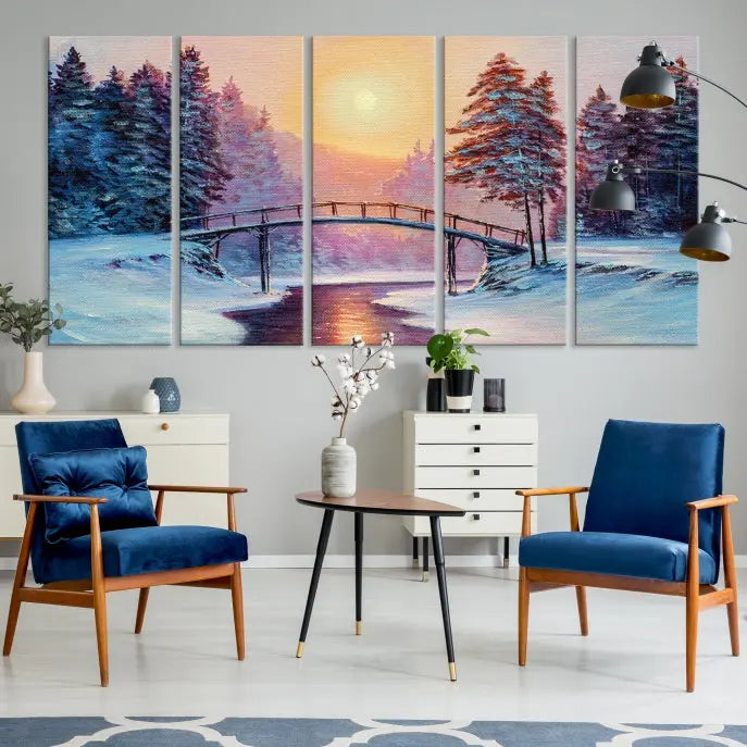 The "Winter Bridge Painting Wall Art Landscape Canvas Print" captures a serene winter landscape across three panels, showcasing a bridge, snowy trees, and a setting sun on museum-quality canvases. Each piece is gallery wrapped for an elegant finish that enhances the tranquility of the scene.