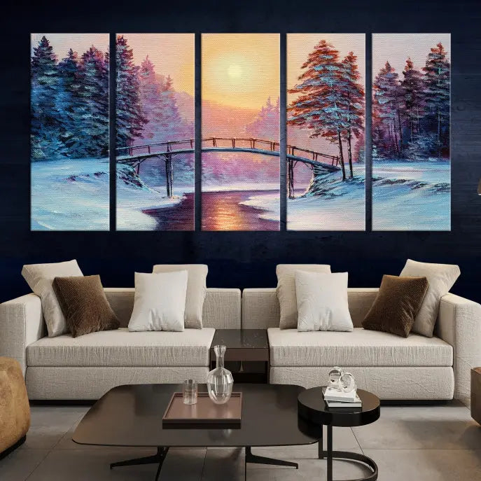 The "Winter Bridge Painting Wall Art Landscape Canvas Print" captures a serene winter landscape across three panels, showcasing a bridge, snowy trees, and a setting sun on museum-quality canvases. Each piece is gallery wrapped for an elegant finish that enhances the tranquility of the scene.