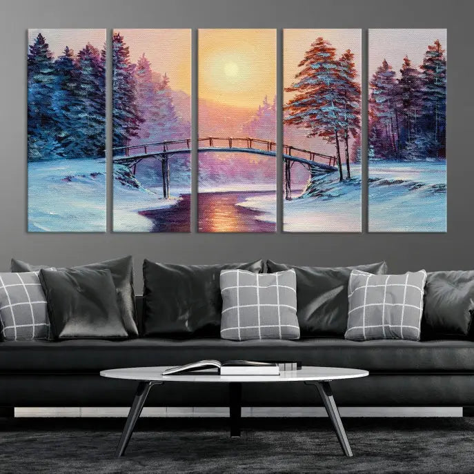 The "Winter Bridge Painting Wall Art Landscape Canvas Print" captures a serene winter landscape across three panels, showcasing a bridge, snowy trees, and a setting sun on museum-quality canvases. Each piece is gallery wrapped for an elegant finish that enhances the tranquility of the scene.