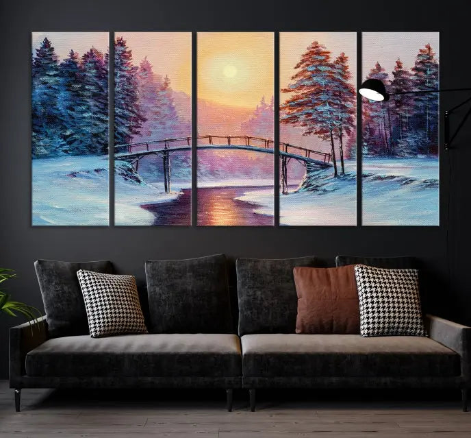 The "Winter Bridge Painting Wall Art Landscape Canvas Print" captures a serene winter landscape across three panels, showcasing a bridge, snowy trees, and a setting sun on museum-quality canvases. Each piece is gallery wrapped for an elegant finish that enhances the tranquility of the scene.