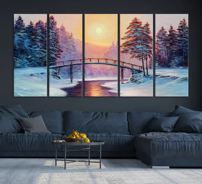 The "Winter Bridge Painting Wall Art Landscape Canvas Print" captures a serene winter landscape across three panels, showcasing a bridge, snowy trees, and a setting sun on museum-quality canvases. Each piece is gallery wrapped for an elegant finish that enhances the tranquility of the scene.