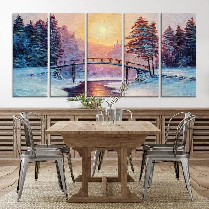 The "Winter Bridge Painting Wall Art Landscape Canvas Print" captures a serene winter landscape across three panels, showcasing a bridge, snowy trees, and a setting sun on museum-quality canvases. Each piece is gallery wrapped for an elegant finish that enhances the tranquility of the scene.