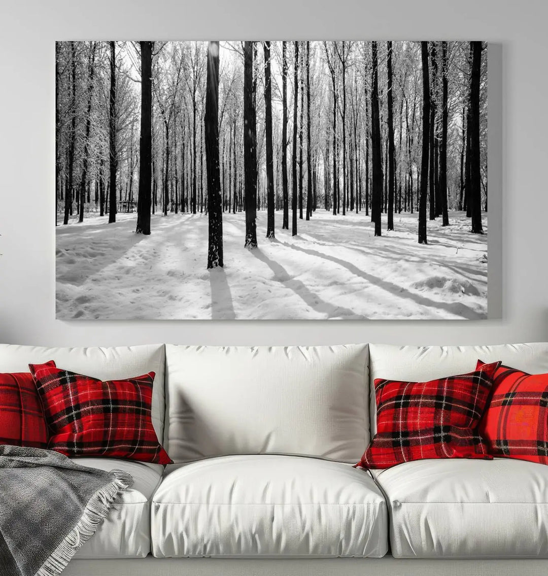 The Winter Forest Wall Art Canvas Print, featuring a snowy forest scene with a UV-protective coating, is displayed in a modern living room.