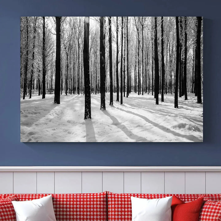 The Winter Forest Wall Art Canvas Print, featuring a snowy forest scene with a UV-protective coating, is displayed in a modern living room.