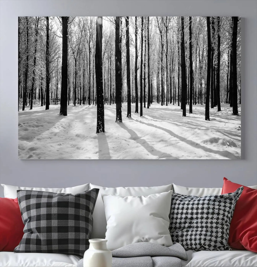 The Winter Forest Wall Art Canvas Print, featuring a snowy forest scene with a UV-protective coating, is displayed in a modern living room.