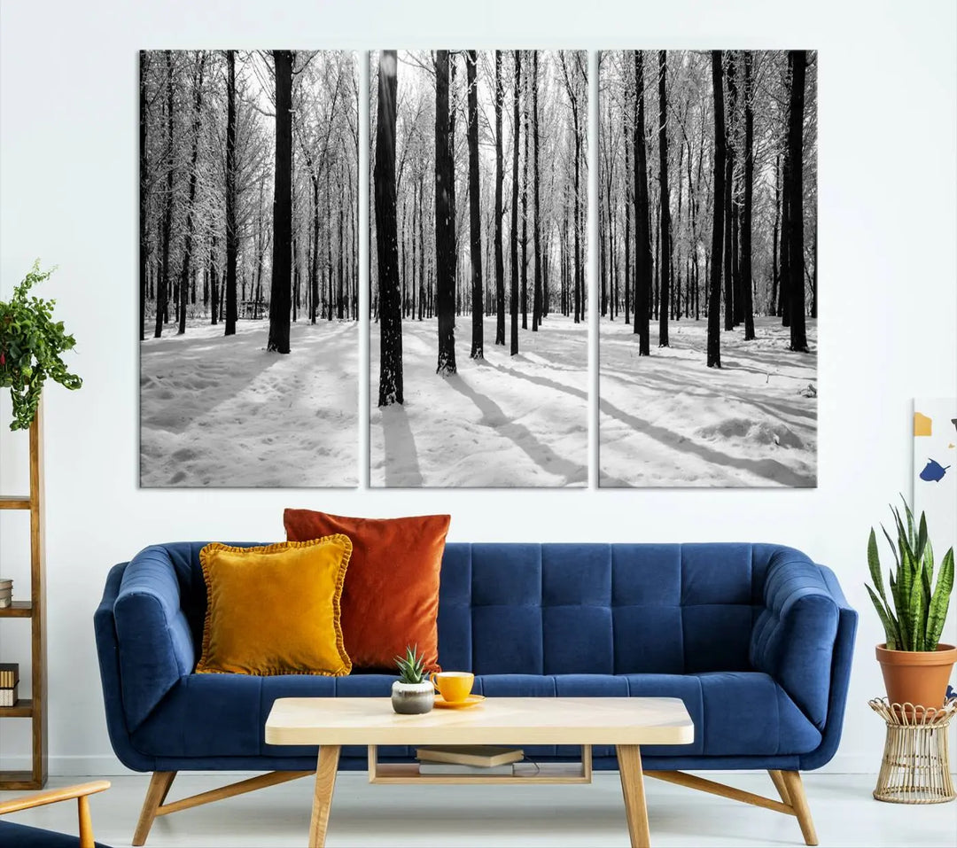 The Winter Forest Wall Art Canvas Print, featuring a snowy forest scene with a UV-protective coating, is displayed in a modern living room.