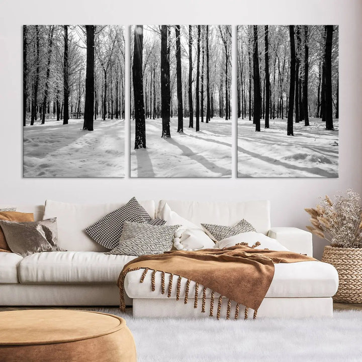 The Winter Forest Wall Art Canvas Print, featuring a snowy forest scene with a UV-protective coating, is displayed in a modern living room.