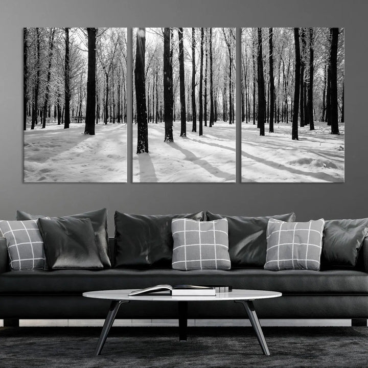 The Winter Forest Wall Art Canvas Print, featuring a snowy forest scene with a UV-protective coating, is displayed in a modern living room.