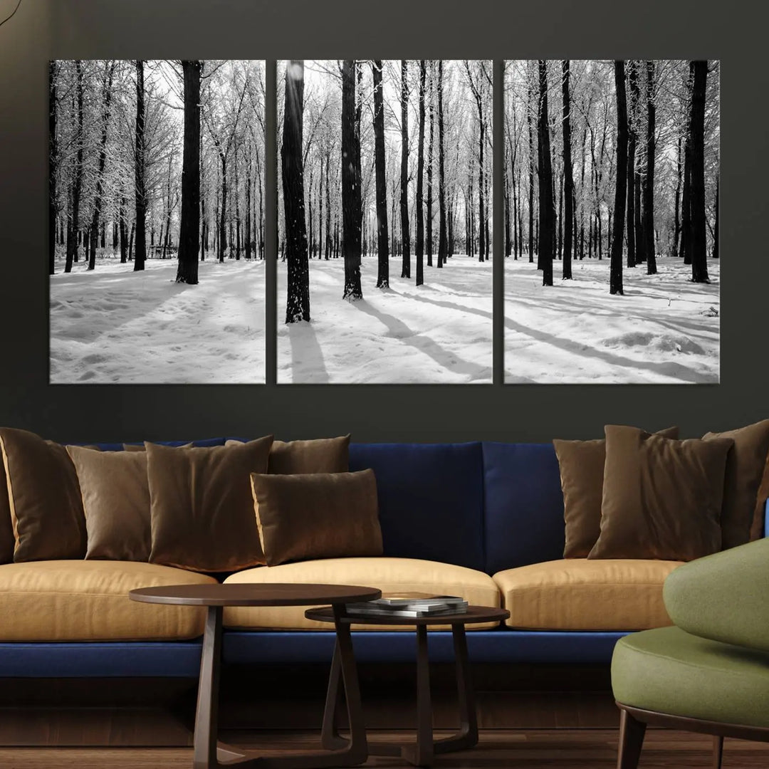 The Winter Forest Wall Art Canvas Print, featuring a snowy forest scene with a UV-protective coating, is displayed in a modern living room.