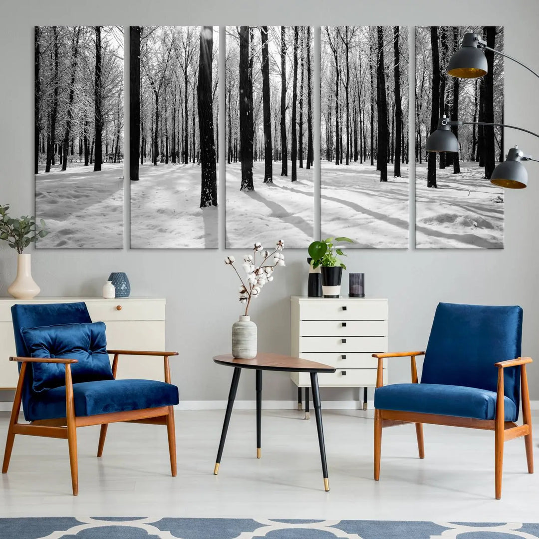 The Winter Forest Wall Art Canvas Print, featuring a snowy forest scene with a UV-protective coating, is displayed in a modern living room.