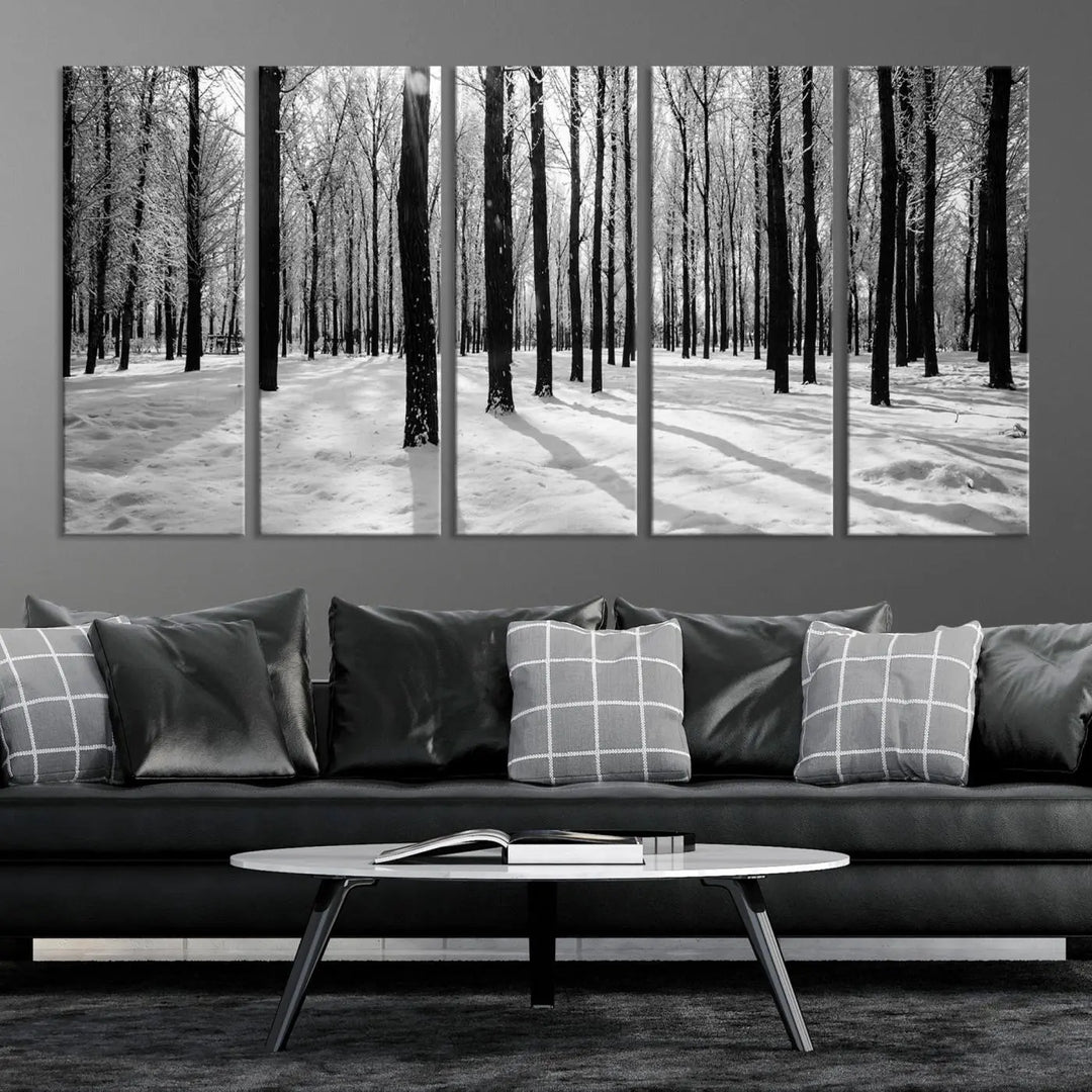 The Winter Forest Wall Art Canvas Print, featuring a snowy forest scene with a UV-protective coating, is displayed in a modern living room.