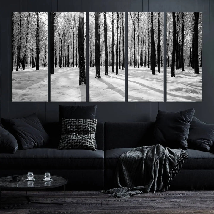 The Winter Forest Wall Art Canvas Print, featuring a snowy forest scene with a UV-protective coating, is displayed in a modern living room.