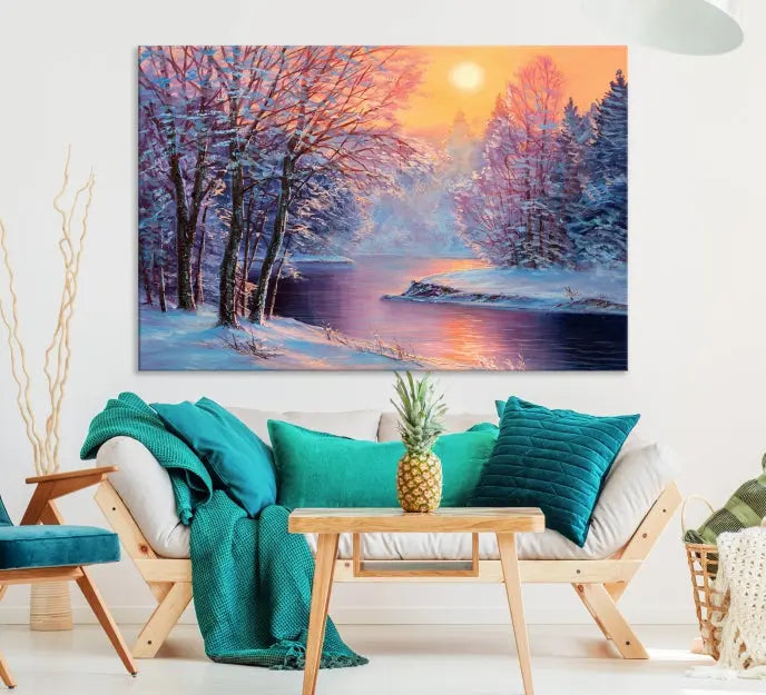 In a cozy living room, you'll find wall art titled "Winter Landscape Painting Wall Art Canvas Print," showcasing a serene snowy river scene at sunset on a museum-quality canvas with gallery-wrapped edges.