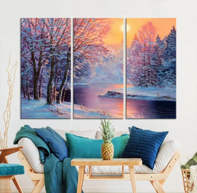 In a cozy living room, you'll find wall art titled "Winter Landscape Painting Wall Art Canvas Print," showcasing a serene snowy river scene at sunset on a museum-quality canvas with gallery-wrapped edges.