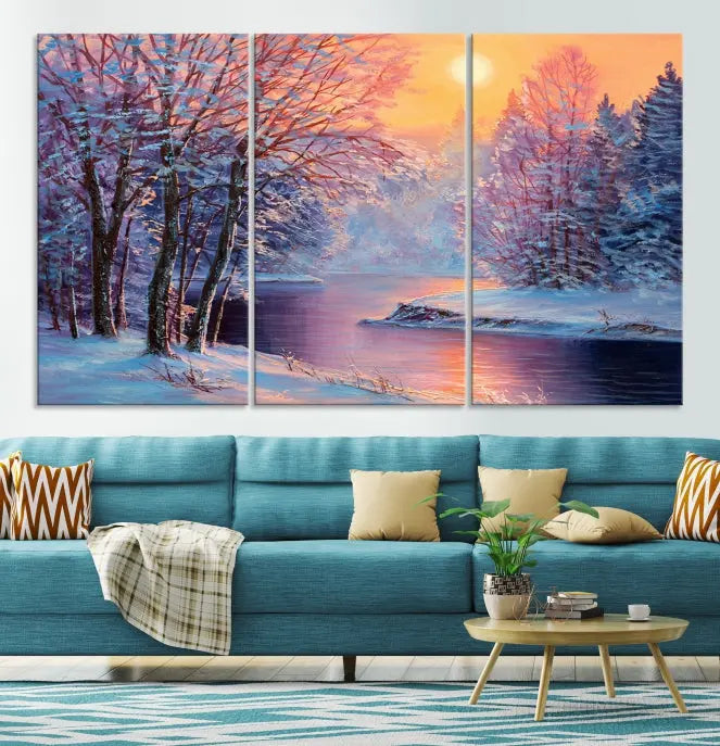 In a cozy living room, you'll find wall art titled "Winter Landscape Painting Wall Art Canvas Print," showcasing a serene snowy river scene at sunset on a museum-quality canvas with gallery-wrapped edges.