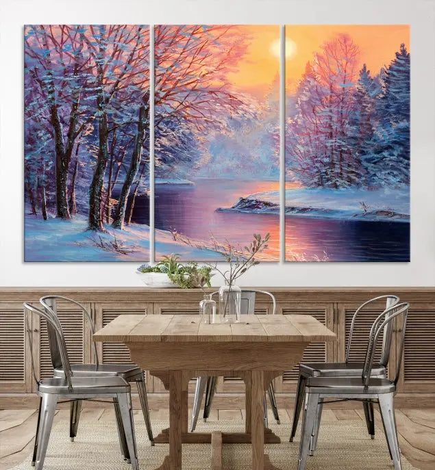 In a cozy living room, you'll find wall art titled "Winter Landscape Painting Wall Art Canvas Print," showcasing a serene snowy river scene at sunset on a museum-quality canvas with gallery-wrapped edges.