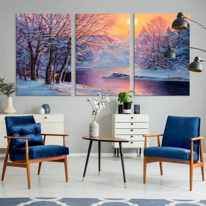 In a cozy living room, you'll find wall art titled "Winter Landscape Painting Wall Art Canvas Print," showcasing a serene snowy river scene at sunset on a museum-quality canvas with gallery-wrapped edges.