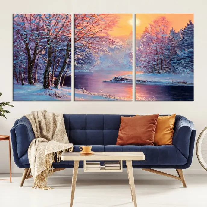 In a cozy living room, you'll find wall art titled "Winter Landscape Painting Wall Art Canvas Print," showcasing a serene snowy river scene at sunset on a museum-quality canvas with gallery-wrapped edges.