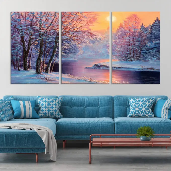 In a cozy living room, you'll find wall art titled "Winter Landscape Painting Wall Art Canvas Print," showcasing a serene snowy river scene at sunset on a museum-quality canvas with gallery-wrapped edges.