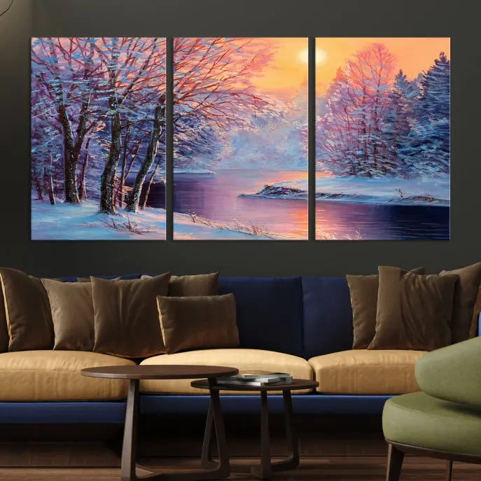 In a cozy living room, you'll find wall art titled "Winter Landscape Painting Wall Art Canvas Print," showcasing a serene snowy river scene at sunset on a museum-quality canvas with gallery-wrapped edges.