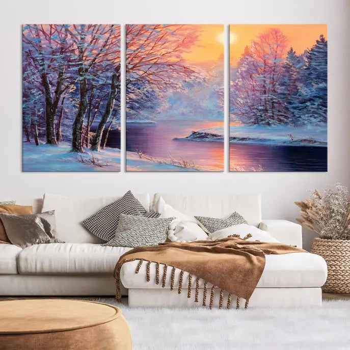 In a cozy living room, you'll find wall art titled "Winter Landscape Painting Wall Art Canvas Print," showcasing a serene snowy river scene at sunset on a museum-quality canvas with gallery-wrapped edges.