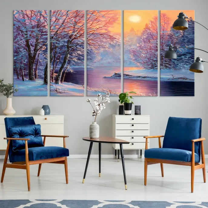 In a cozy living room, you'll find wall art titled "Winter Landscape Painting Wall Art Canvas Print," showcasing a serene snowy river scene at sunset on a museum-quality canvas with gallery-wrapped edges.