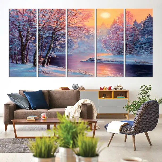 In a cozy living room, you'll find wall art titled "Winter Landscape Painting Wall Art Canvas Print," showcasing a serene snowy river scene at sunset on a museum-quality canvas with gallery-wrapped edges.