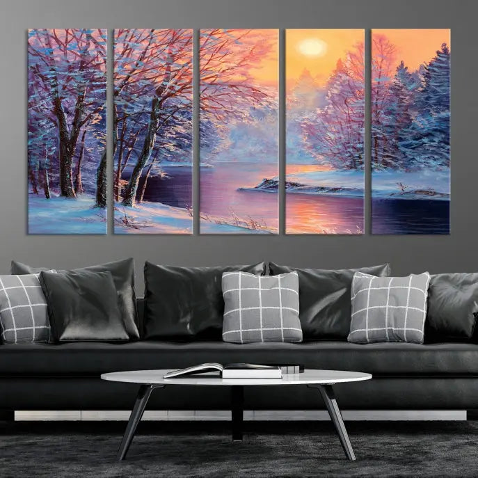 In a cozy living room, you'll find wall art titled "Winter Landscape Painting Wall Art Canvas Print," showcasing a serene snowy river scene at sunset on a museum-quality canvas with gallery-wrapped edges.