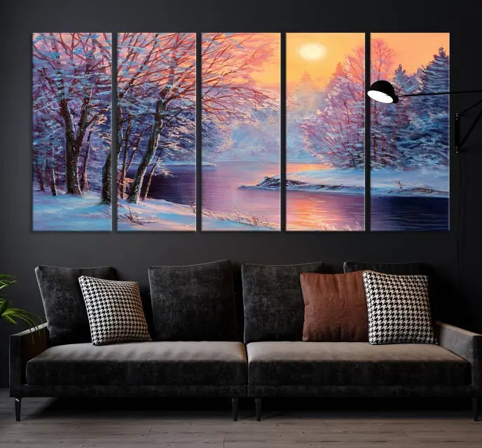 In a cozy living room, you'll find wall art titled "Winter Landscape Painting Wall Art Canvas Print," showcasing a serene snowy river scene at sunset on a museum-quality canvas with gallery-wrapped edges.