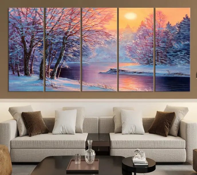 In a cozy living room, you'll find wall art titled "Winter Landscape Painting Wall Art Canvas Print," showcasing a serene snowy river scene at sunset on a museum-quality canvas with gallery-wrapped edges.