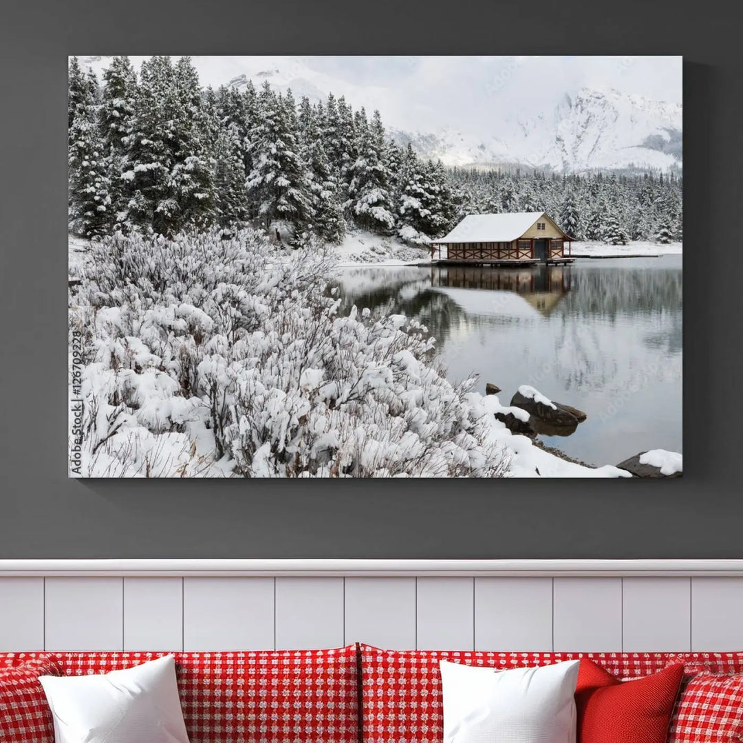 Experience the beauty of winter with the "Cabin by the Lake Canvas Wall Art," showcasing a serene snowy landscape. This rustic nature decor features a cozy cabin nestled amid snow-laden trees, set against a breathtaking mountain view, perfect for enhancing your living room.