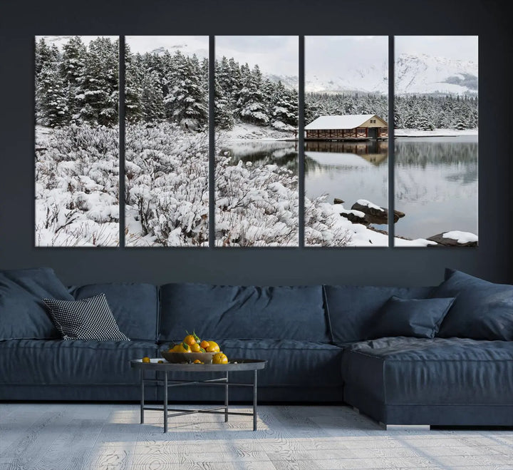 Experience the beauty of winter with the "Cabin by the Lake Canvas Wall Art," showcasing a serene snowy landscape. This rustic nature decor features a cozy cabin nestled amid snow-laden trees, set against a breathtaking mountain view, perfect for enhancing your living room.