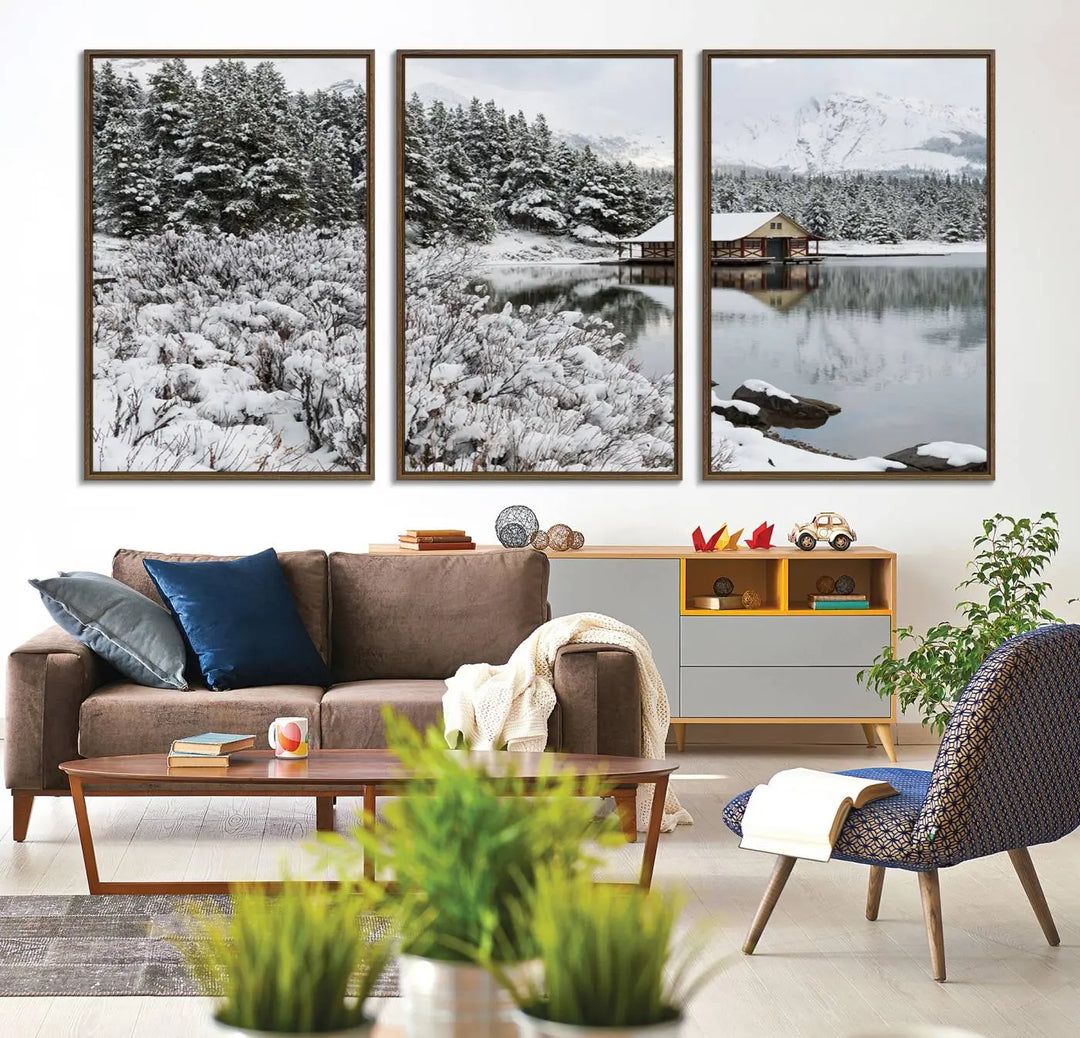 Experience the beauty of winter with the "Cabin by the Lake Canvas Wall Art," showcasing a serene snowy landscape. This rustic nature decor features a cozy cabin nestled amid snow-laden trees, set against a breathtaking mountain view, perfect for enhancing your living room.