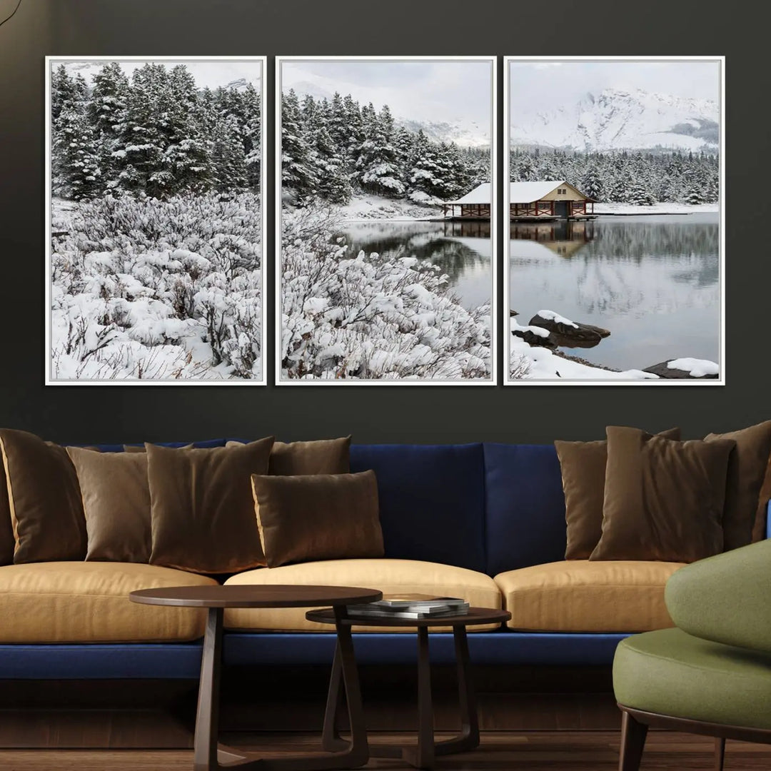 Experience the beauty of winter with the "Cabin by the Lake Canvas Wall Art," showcasing a serene snowy landscape. This rustic nature decor features a cozy cabin nestled amid snow-laden trees, set against a breathtaking mountain view, perfect for enhancing your living room.