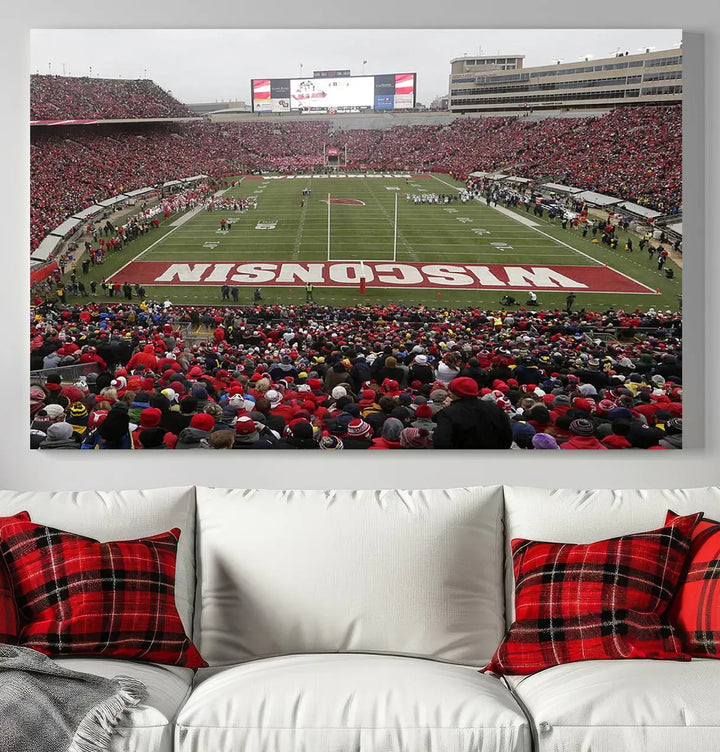 A living room exhibits the premium Wisconsin Badgers Football Team Print - Madison Camp Randall Stadium Wall Art Canvas Print, a triptych displaying an exciting game at Wisconsin. This canvas artwork infuses the space with vibrant energy.