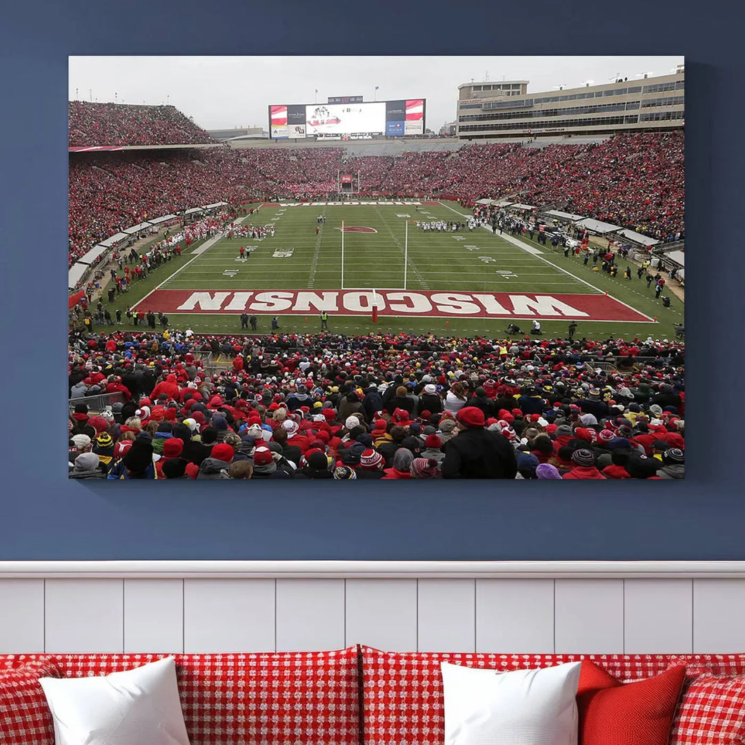 A living room exhibits the premium Wisconsin Badgers Football Team Print - Madison Camp Randall Stadium Wall Art Canvas Print, a triptych displaying an exciting game at Wisconsin. This canvas artwork infuses the space with vibrant energy.