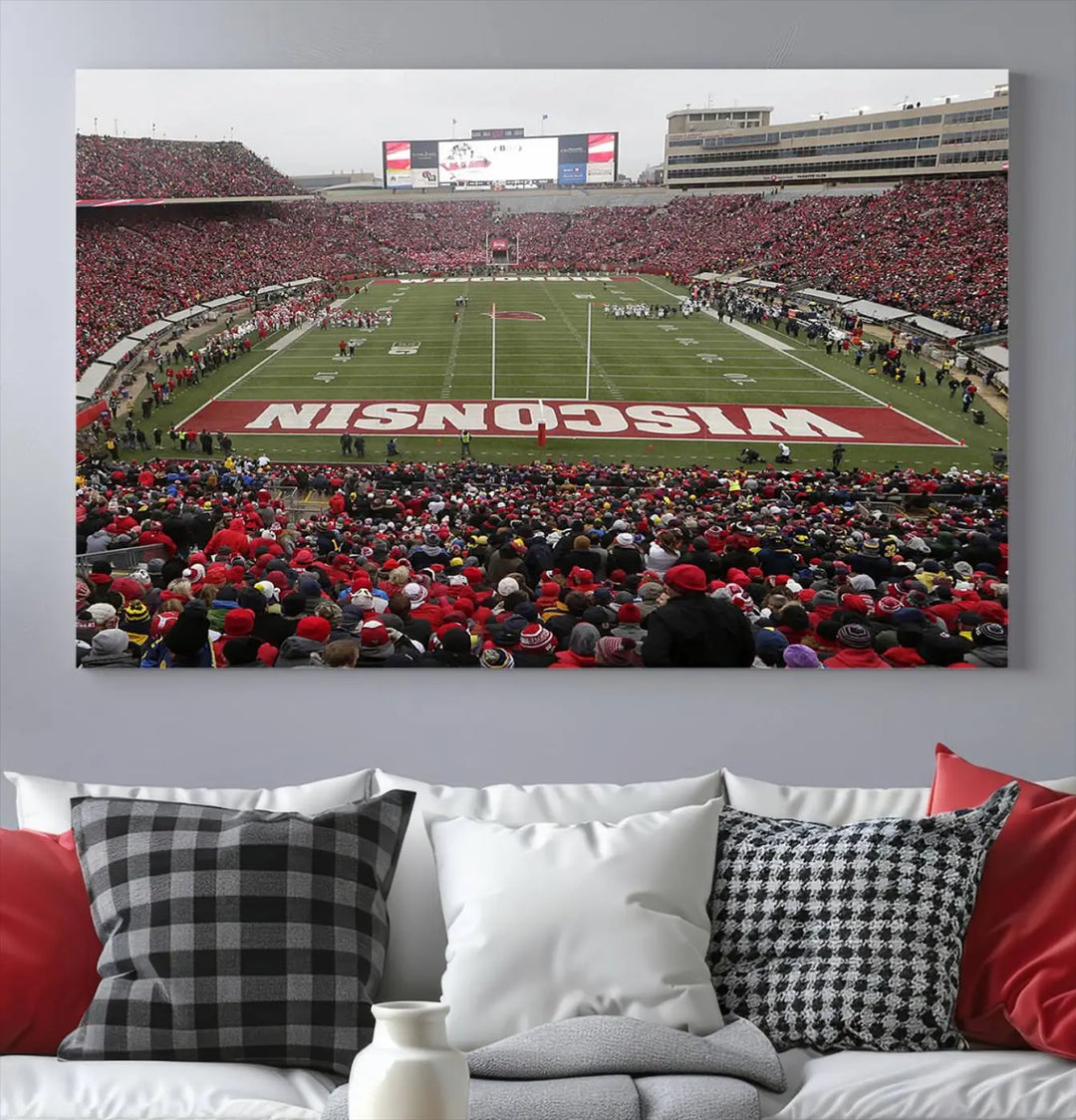 A living room exhibits the premium Wisconsin Badgers Football Team Print - Madison Camp Randall Stadium Wall Art Canvas Print, a triptych displaying an exciting game at Wisconsin. This canvas artwork infuses the space with vibrant energy.